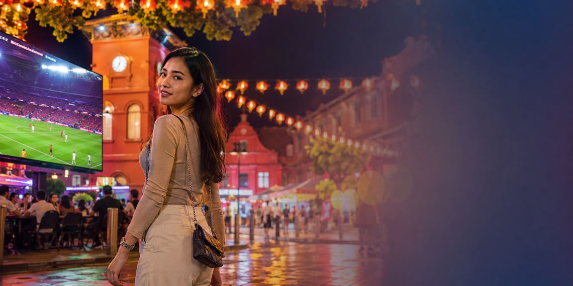 Football betting scene in Melaka with a local heritage cultural backdrop